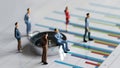 Business concept with miniature people standing on a graph.es Royalty Free Stock Photo